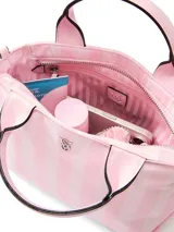 Mini bolso bandolera Victoria's Secret con diseño de rayas verticales en tonos rosados, asas cortas de mano y correa ajustable y extraíble.