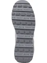 Zapatillas Tommy Jeans blancas y grises con detalles en rojo y azul. Presentan el logo de Tommy Jeans en el lateral y suela dentada. Confeccionadas con poliéster reciclado.