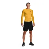 Calza deportiva corta Under Armour modelo HeatGear Compression, color negro con cintura elástica ancha gris y logo de la marca estampado en blanco en la pierna derecha.