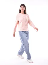 Remera de manga larga color beige, con cuello redondo y estampado frontal que dice "Magic is something you make" en color lila.