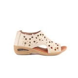 Sandalia baja de cuero color beige, con diseño cerrado en el talón y perforaciones circulares en el empeine. Cuenta con suela de goma con cámara de aire en el talón y plantilla marrón.