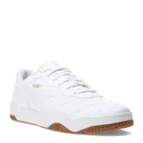 Championes urbanos Puma modelo Tifosi, color blanco con detalles en dorado. Presentan un diseño con costuras acolchadas en la puntera, logo lateral y suela de goma color caramelo.
