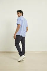 Camisa de manga corta color kaki con cuello abotonado, bolsillo de parche en el pecho y botones de madera.