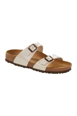 Sandalias Birkenstock modelo Sydney, color blanco perlado, con dos tiras ajustables con hebillas color cobre.