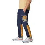 Pantalón cortavientos azul marino con tecnología Omni-Shield repelente al agua y manchas, bolsillos laterales con cierre y detalles en tono mostaza y verde.