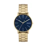 Reloj Skagen Signatur con caja dorada de acero inoxidable y esfera azul con agujas doradas. La correa es de acero inoxidable dorado con eslabones.