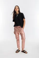 Pantalón de lino metalizado color nude, con cintura alta elástica, corte pitillo, bolsillos laterales y dos bolsillos falsos en la parte trasera.