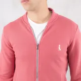 Campera bomber color salmón de algodón fino de punto, con cierre frontal, cuello y puños acanalados.