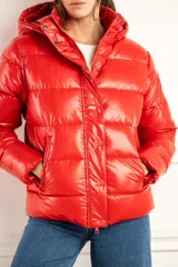 Campera puffer roja con capucha, calce al cuerpo y terminación engomada.