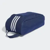 Bolso para calzado Adidas de la línea Tiro League, color azul marino. Diseñado para transportar botines de fútbol, cuenta con un panel lateral de malla para ventilación, asa de mano superior y cierre de solapa. Presenta las tres tiras icónicas y el logo de la marca en color blanco.