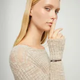 Pulsera ajustable de hilo elástico marrón, con un dije central de corazón plateado de forma orgánica y un cierre magnético plateado.