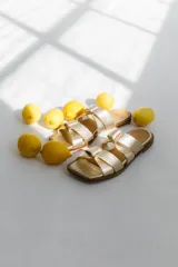 Sandalias de cuero color camel, con punta cuadrada y dos tiras anchas con detalle de nudo.