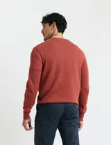 Sweater de punto con escote en V y manga larga, confeccionado en tejido acrílico con textura suave.