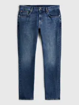Jeans Tommy Hilfiger modelo Tapered Moore de corte recto y tiro medio, en color azul con lavado Nori Indigo. Confeccionados en mezcla de algodón y cáñamo, cuentan con diseño clásico de cinco bolsillos, cierre de botón y cremallera.