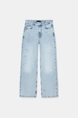 Jeans de tiro medio, corte loose straight, color celeste claro con efecto de salpicaduras de pintura en varios colores. Cierre frontal con cremallera y botón, y diseño de cinco bolsillos.