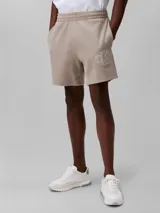Short de jogging color beige, de tejido de punto de algodón acanalado, con cintura elástica, bolsillos laterales y trasero. Presenta logo CK bordado en blanco en la pierna izquierda.