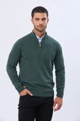 Buzo tejido de punto color verde oscuro, con cuello alto y cierre frontal parcial. Presenta un detalle en cuero en el tirador del cierre y un pequeño logo bordado en el pecho.