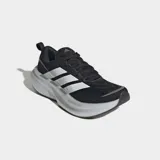 Championes de running Adidas Supernova Glide, color negro con las tres tiras características en blanco en los laterales y suela de plataforma amortiguada blanca. Confeccionados con exterior textil liviano y suela de caucho.