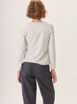 Pantalon de corte recto y tiro medio, confeccionado en tejido de lana con sutiles rayas verticales. Presenta bolsillos traseros aplicados, costuras reforzadas en las rodillas y ruedo con dobladillo.
