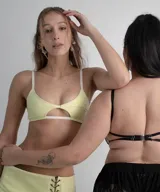 Top tipo bra de cuerina con textura efecto croco en color amarillo limón, con diseño de aberturas frontales y detalles de tiras elásticas blancas en breteles y bajo busto.