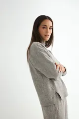 Conjunto de dos piezas compuesto por un sweater de cuello alto con aberturas laterales en el ruedo y un pantalón de corte recto y holgado, ambos confeccionados en tejido de punto suave.