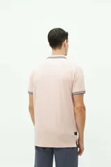 Remera polo azul marino de manga corta, con cuello y puños a rayas blancas y verde militar. Presenta un bolsillo en el pecho con detalle de franja a rayas y el logo de la marca "Brooksfield" bordado en dorado.