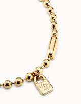 Collar de cuentas esféricas metálicas con baño de oro de 18k, con cierre de tipo hormiga.