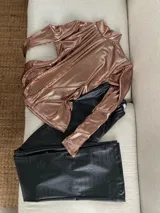 Polera de manga larga color cobre con efecto brillante y frunces en los hombros, cuello alto y caída recta.