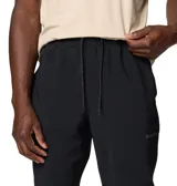 Pantalon tipo jogger de hombre, color negro, con cintura elástica ajustable con cordón, bolsillos delanteros, bolsillo trasero con cremallera y dobladillos elásticos en los tobillos. Cuenta con tecnología Omni-SHIELD resistente al agua y a las manchas, y detalles reflectantes.