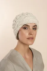 Gorro tejido a mano color crudo, con hilado rueca y variedad de texturas: punto garbanzo y guarda con diseño de trenzas.