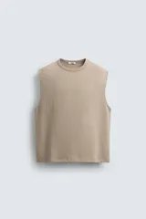 Sudadera sin mangas de corte relajado, confeccionada en tejido con textura irregular y acabado interior tipo rizo. Presenta cuello redondo y diseño de sisa amplia.