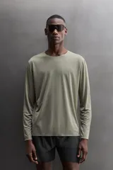 Camiseta de running de manga larga confeccionada en tejido técnico semitransparente, ligero y elástico. Presenta cuello redondo, aberturas laterales en el bajo y acabados termofijados.