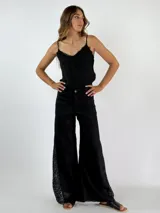 Pantalón de lino color beige, corte palazzo, con detalle de crochet en el lateral inferior.