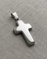 Collar de cadena fina de acero con dije colgante en forma de cruz de acabado brillante.