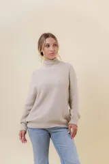 Polera de tejido de punto con textura marcada, cuello alto y diseño oversize con hombros caídos y terminaciones acanaladas.
