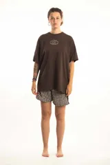 Remera verde militar con efecto gastado, corte oversize y estampado frontal con logo circular en color crudo.