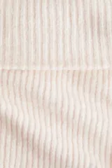 Top de punto acanalado con diseño ajustado, manga larga y escote tipo bote con solapa vuelta.