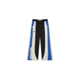 Pantalón de jogging Eme Studios modelo Arco Midnight Sweatpants, de diseño multicolor con paneles negros, blancos y laterales azules con patrón de damero. Cuenta con cintura elástica, cierres laterales y el nombre de la marca estampado en la pierna.