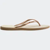 Ojotas Havaianas modelo Slim Point, con suela y tiras más finas, punta ligeramente puntiaguda y borde contrastante. Las tiras son de color lila claro con el logotipo de Havaianas en metalizado. La suela es lila claro con borde exterior en color terracota/rosado oscuro.