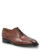 Zapato de vestir tipo Oxford en cuero color marrón, con puntera reforzada y cierre mediante cordones. Presenta un diseño clásico con suela mixta de cuero y goma.
