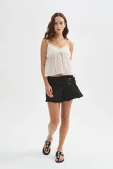 Musculosa blanca de lyocell, con tirantes finos regulables, escote en V y detalle de volados en el delantero, de diseño holgado.
