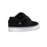 Championes de skate Emerica modelo The Low Vulc, color negro con detalles en dorado. Presentan una construcción de gamuza y lona, con suela vulcanizada blanca y logo de la marca en el lateral y talón.