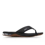 Ojotas Reef Anchor negras con suela marrón y cámara de aire visible en el talón.