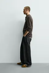 Jersey relaxed fit de punto acanalado color marrón oscuro, con cuello redondo tipo panadera y cierre frontal de tres botones. Tiene manga larga y efecto lavado.