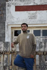 Remera blanca de algodón con cuello redondo y manga corta. Estampado pequeño en el pecho de una mano haciendo el signo de la paz en color celeste.