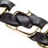 Pulsera de cuero trenzado color negro con detalles de acero dorado. Cierre con imán.