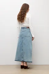 Pollera larga de denim en tono celeste, de corte recto con diseño bicolor en el dobladillo inferior. Cuenta con tiro alto, bolsillos y costuras visibles.