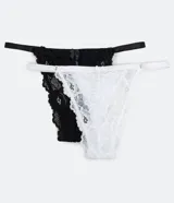 Pack de dos tangas colaless de encaje floral, una blanca y otra negra, con laterales finos y moño decorativo en el frente.