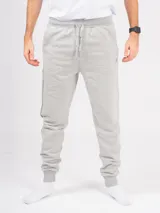 Pantalón babucha deportivo unisex azul, de tiro alto, con puños y cordones ajustables.