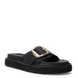 Sandalias planas Miss Carol modelo Milla, color negro, con una tira ancha en el empeine y una hebilla metálica grande en tono dorado. Cuenta con suela flatform dentada.